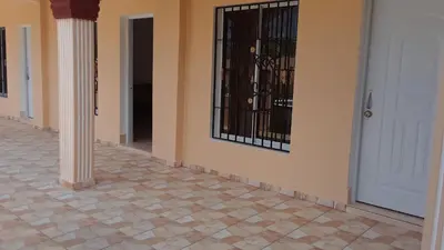 a hallway with a door with a iron gate at Apartamentos Nuevo Amanecer in Río San Juan