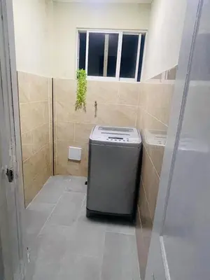 a small refrigerator in a bathroom with a window at Cerca del aeropuerto los frailes I in Los Frailes