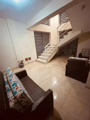 a living room with a couch and a staircase at Cerca del aeropuerto los frailes I in Los Frailes
