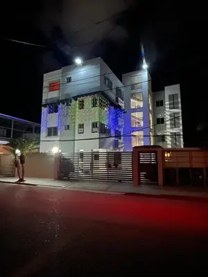 a building with blue lights on it at night at Cerca del aeropuerto los frailes I in Los Frailes