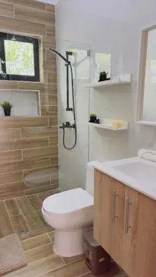 a bathroom with a toilet and a shower and a sink at Villa YOSYMART Poolside Retreat private WIFI Luxury BBQ side in Punta Cana