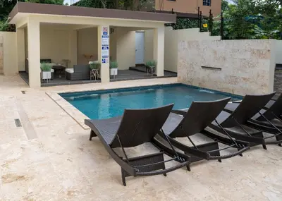 a group of chairs sitting next to a swimming pool at La Isla Royal - Abismo Celeste in Miches