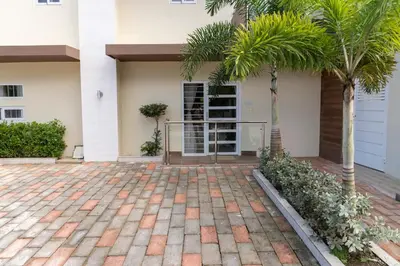 a house with a palm tree and a patio at La Isla Royal - Abismo Celeste in Miches