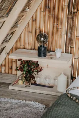 a wooden shelf with a plant and candles in a room at OYA New Earth Luxury Romantic Glamping with Private Outdoor Bath in Jamao al Norte