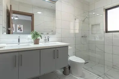 a white bathroom with a sink and a toilet at Kcasama Castle Villa 1108 in Sosúa