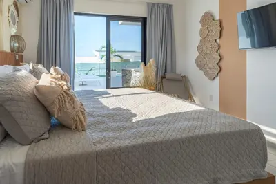 a bedroom with a bed with a view of the ocean at Kcasama Castle Villa 1108 in Sosúa