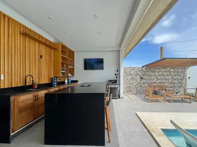 a kitchen with a black counter top and a patio at Villa Solana in Cabrera Dominican Republic in Cabrera