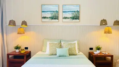 a bedroom with a bed with three pictures on the wall at Villa Solana in Cabrera Dominican Republic in Cabrera