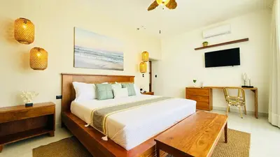 a bedroom with a bed and a desk and a television at Villa Solana in Cabrera Dominican Republic in Cabrera