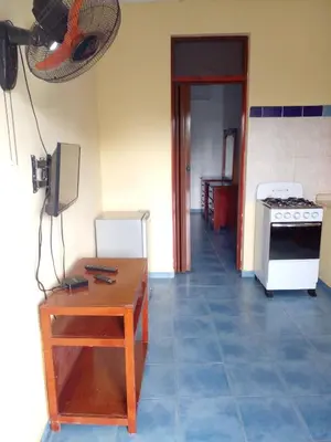 a kitchen with a table and a stove at Apartamentos grigri in Río San Juan