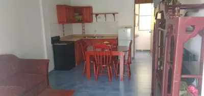 a kitchen with a table and chairs in a room at Apartamentos grigri in Río San Juan