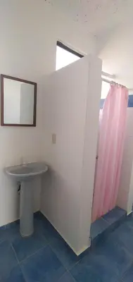a bathroom with a sink and a window at Apartamentos grigri in Río San Juan
