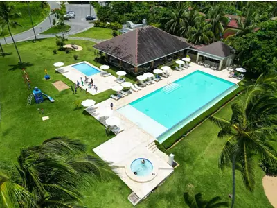 an overhead view of a swimming pool in front of a house at Playa Bonita Modern Beachfront Penthouse - 3BR in Las Terrenas