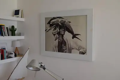 a picture of a man in a hat on a wall at Playa Bonita Modern Beachfront Penthouse - 3BR in Las Terrenas