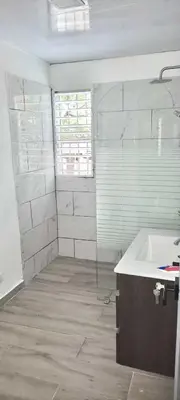 a bathroom with a tub and a sink and a window at Casa Valentina in Río San Juan