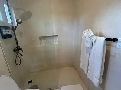 a bathroom with a shower with a toilet and towels at Charming Villa GUGI #80 in Palmeras de Coson, Las Terrenas in Las Terrenas