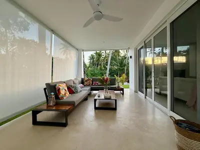 a living room with a couch and a ceiling fan at Charming Villa GUGI #80 in Palmeras de Coson, Las Terrenas in Las Terrenas