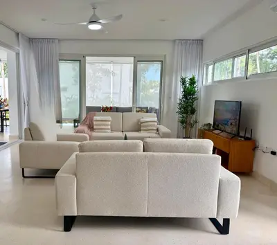 a living room with white furniture and large windows at Charming Villa GUGI #80 in Palmeras de Coson, Las Terrenas in Las Terrenas