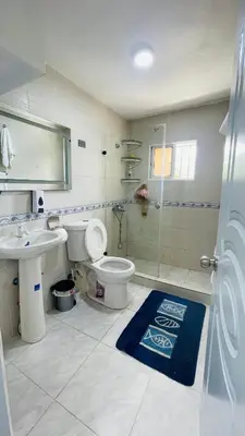 a bathroom with a toilet and a sink and a shower at beachfront apartment in La Puntica de Juan Dolio