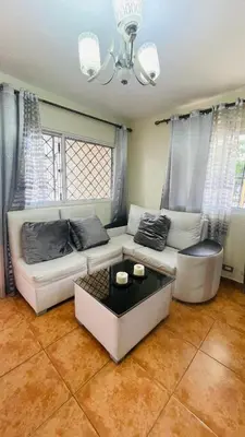 a living room with a white couch and a table at beachfront apartment in La Puntica de Juan Dolio