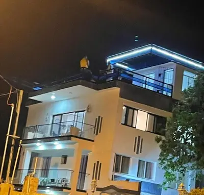a large white building with a balcony at night at beachfront apartment in La Puntica de Juan Dolio