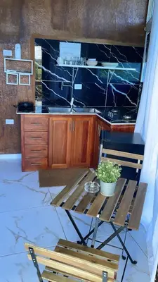 a kitchen with a table and a bench and a counter at Guest-House Caracol 1- 2 Pax, vista al mar in Las Galeras