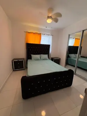 a bedroom with a large bed with an orange curtain at Cozy apartment in Licey al Medio in Licey al Medio