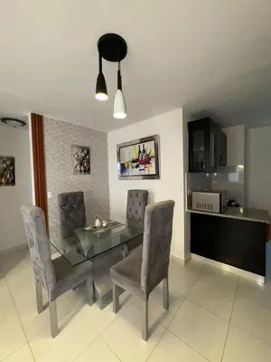 a dining room with a glass table and chairs at Cozy apartment in Licey al Medio in Licey al Medio
