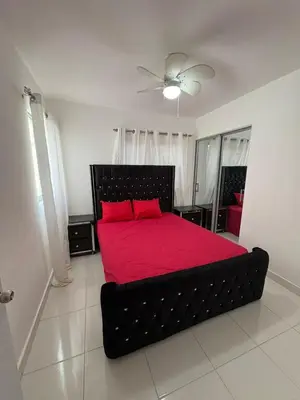 a bedroom with a black bed with red sheets at Cozy apartment in Licey al Medio in Licey al Medio