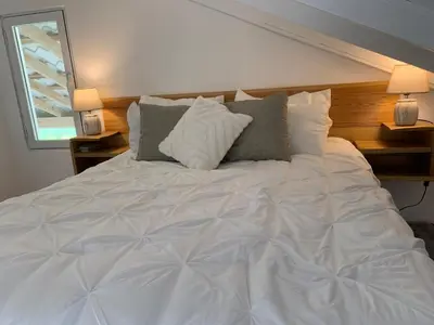 a large white bed in a bedroom with two lamps at Villa Brisa del Caribe in Las Terrenas