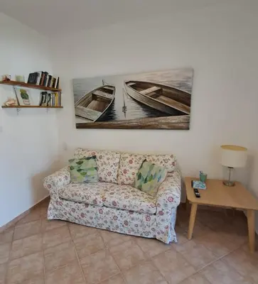 a living room with a couch and a table at Apartamentos Cayuco 28 in La Laguna
