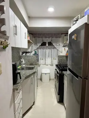 a small kitchen with a sink and a stove at Apartamento en Santo Domingo Pablo mella morales in Hato Nuevo