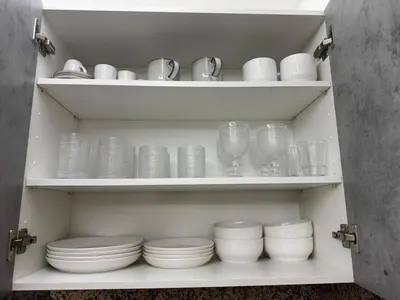 a cabinet filled with plates and cups and bowls at Chic City Apartment Walk to Everything! in Santo Domingo
