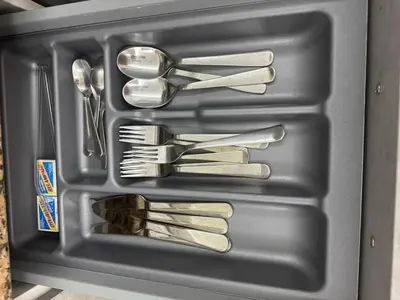 a tray with silver utensils in a refrigerator at Chic City Apartment Walk to Everything! in Santo Domingo