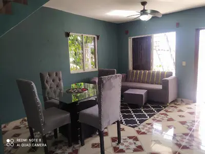 a living room with a couch and a table and chairs at Recidencia Don Carlos