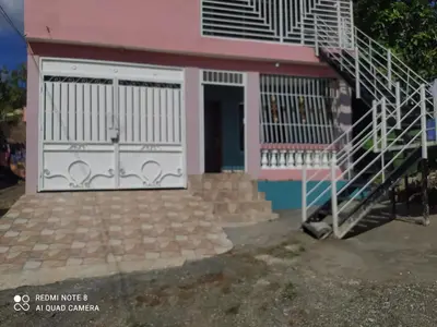 a house with a white gate and stairs at Recidencia Don Carlos