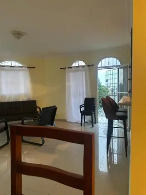a living room with a couch and chairs and windows at Desconecta para volver a conectar - La bebida tiene costo adicional in Miches