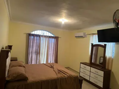 a bedroom with a bed and a mirror and a dresser at Desconecta para volver a conectar - La bebida tiene costo adicional in Miches
