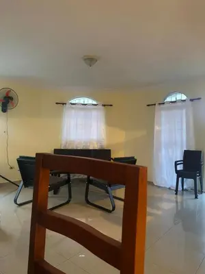 a room with two windows and a table and chairs at Desconecta para volver a conectar - La bebida tiene costo adicional in Miches