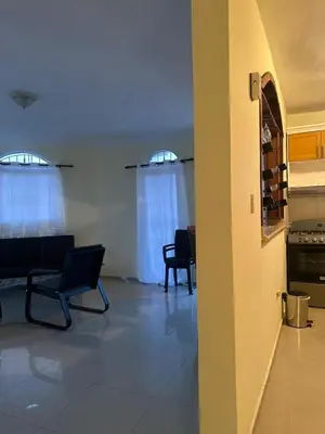 a living room with two chairs and a kitchen at Desconecta para volver a conectar - La bebida tiene costo adicional in Miches