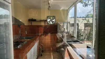 a kitchen with a sink and a large window at Casa club by mama nelsy in Santa Cruz de El Seibo
