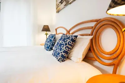 a bedroom with a bed with blue and white pillows at Villa Playa Colorada Eco-Luxury Beachfront Retreat in La Colmena