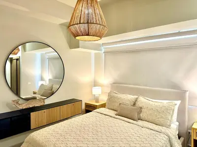 a bedroom with a bed and a large mirror at Paradises Room in Boca Chica
