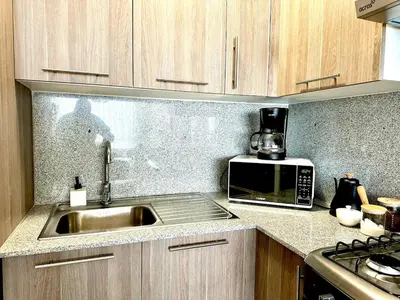 a kitchen with a sink and a microwave at Paradises Room in Boca Chica