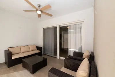 a living room with a couch and a ceiling fan at TRACADERO Ocean Pearl Suite in La Laguna