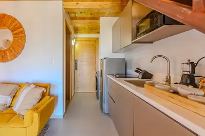 a kitchen with a yellow couch and a sink at Esprit Caribbean Bayahibe by Caribbean Paradise Rentals in Bayahibe