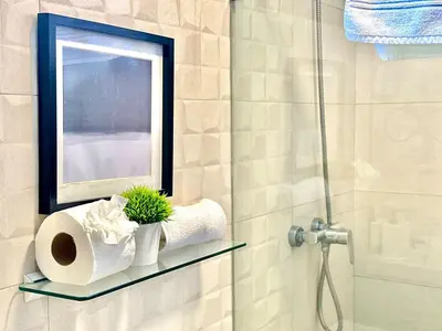 a bathroom with a window and a shelf with toilet paper at Suite Panorama in Colorado