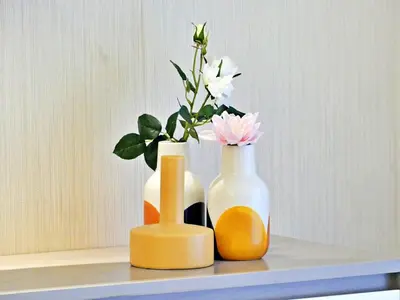 two vases with flowers in them sitting on a shelf at Suite Panorama in Colorado