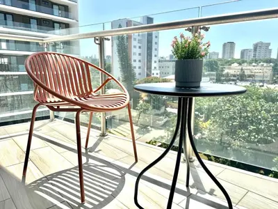 a chair and a table on a balcony at Suite Panorama in Colorado