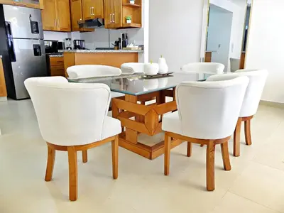 a dining room with a table and white chairs at Acogedor y Familiar in Colorado